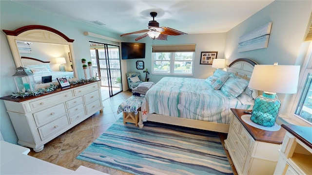 tiled bedroom featuring ceiling fan