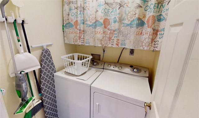 clothes washing area with separate washer and dryer