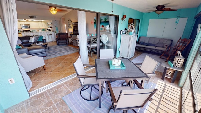 dining room featuring light tile patterned floors and ceiling fan