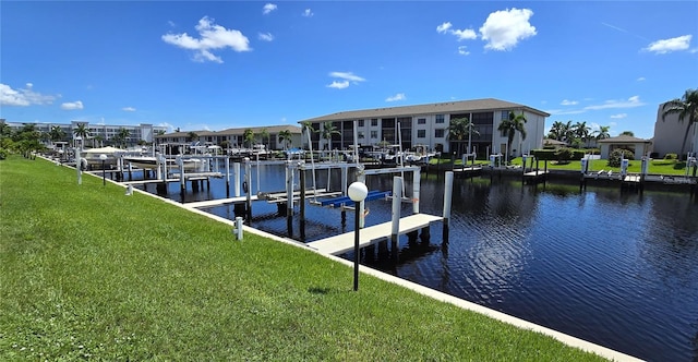 view of dock with a water view and a lawn