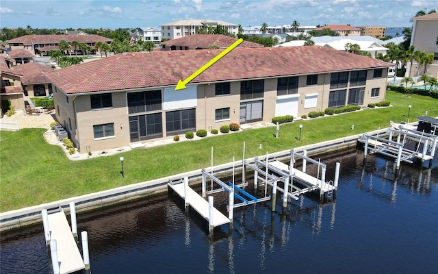 view of dock featuring a water view and a yard