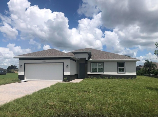 view of front of house featuring a garage and a front lawn