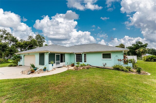 ranch-style home with a garage and a front yard