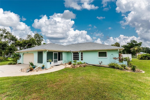 exterior space featuring stucco siding, concrete driveway, a front yard, fence, and a garage