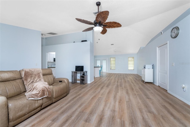 living room featuring lofted ceiling, ceiling fan, light wood-style flooring, visible vents, and baseboards