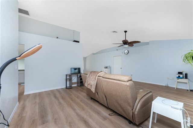 living room with lofted ceiling, light hardwood / wood-style floors, and ceiling fan