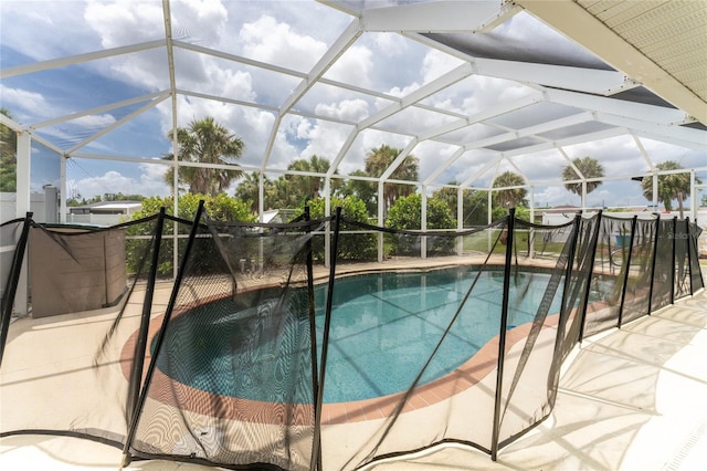 view of pool featuring a patio and glass enclosure