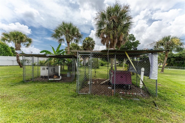 view of play area with an outbuilding, a lawn, fence, and exterior structure