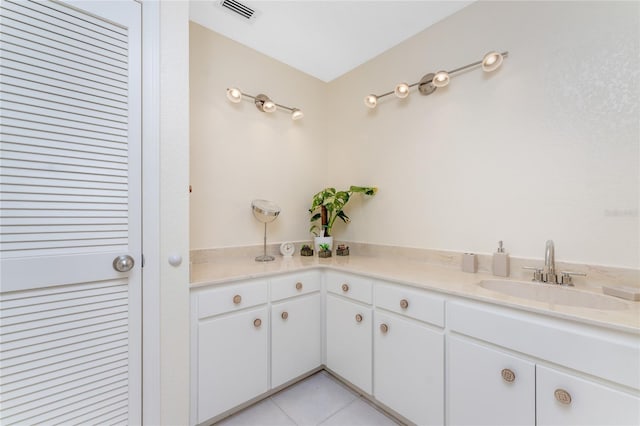 bathroom with a sink, tile patterned flooring, and visible vents