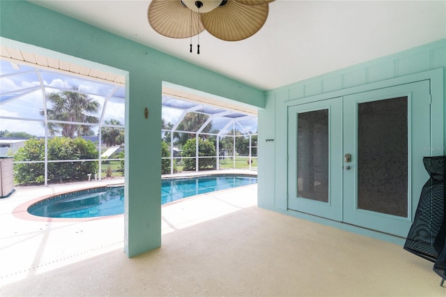 outdoor pool featuring a lanai, a patio, ceiling fan, and french doors