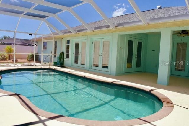 view of pool featuring a lanai, a fenced in pool, french doors, and a patio area