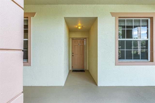 view of exterior entry featuring stucco siding