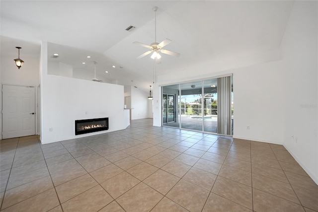 unfurnished living room with light tile patterned floors, visible vents, a glass covered fireplace, ceiling fan, and high vaulted ceiling