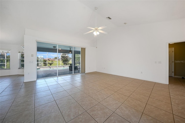 unfurnished room with light tile patterned flooring, high vaulted ceiling, and ceiling fan