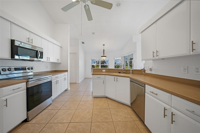 kitchen featuring decorative light fixtures, ceiling fan, stainless steel appliances, white cabinets, and light tile patterned floors