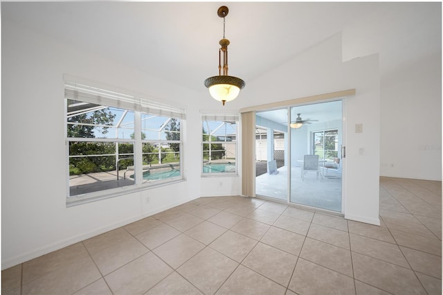 tiled empty room featuring ceiling fan and vaulted ceiling