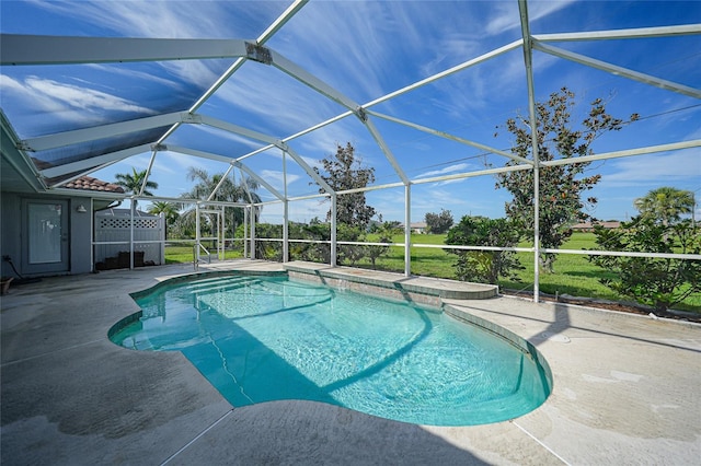 view of swimming pool with a patio and glass enclosure