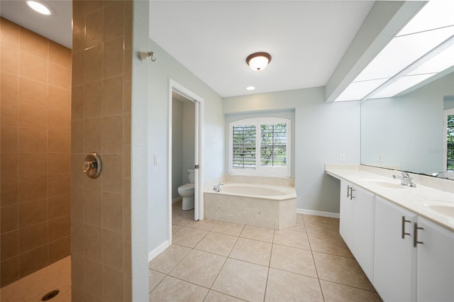 full bathroom featuring tile patterned floors, toilet, a sink, a tile shower, and a bath