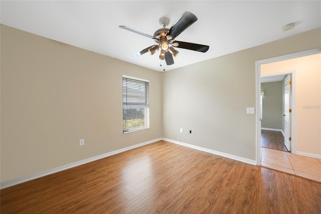 spare room with ceiling fan and light wood-type flooring