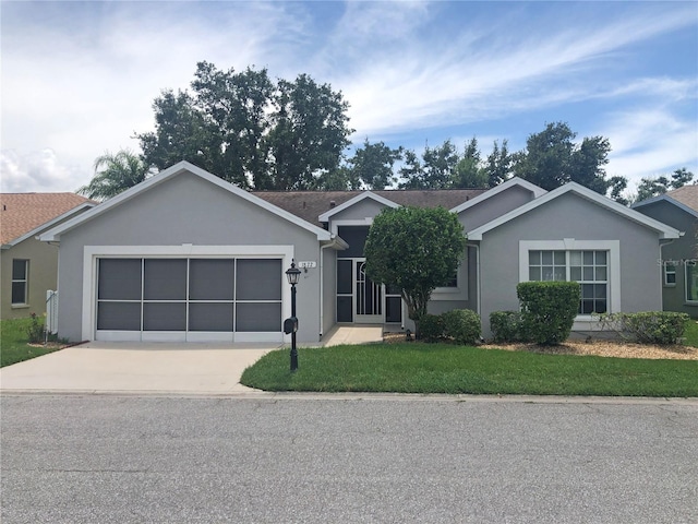 single story home featuring a garage and a front lawn