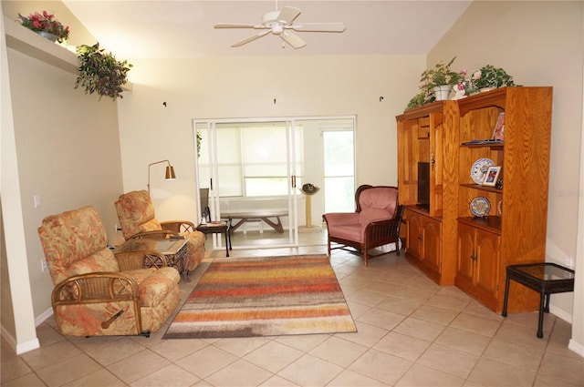 tiled living room with ceiling fan and vaulted ceiling