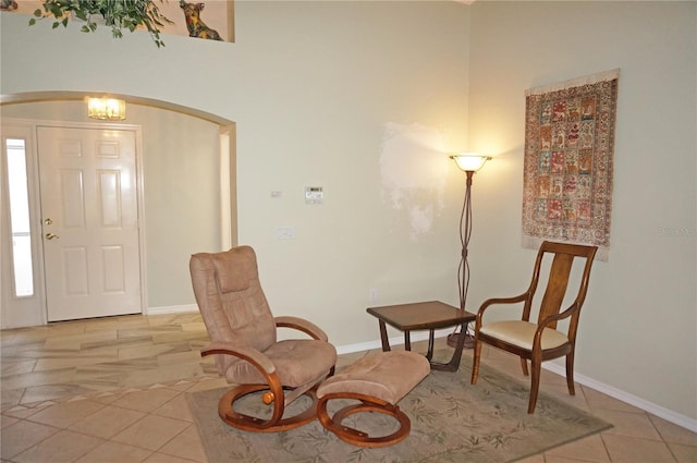 living area with a notable chandelier and light tile patterned floors