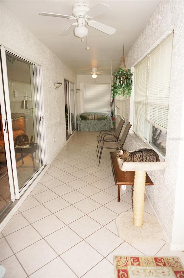 sunroom featuring ceiling fan