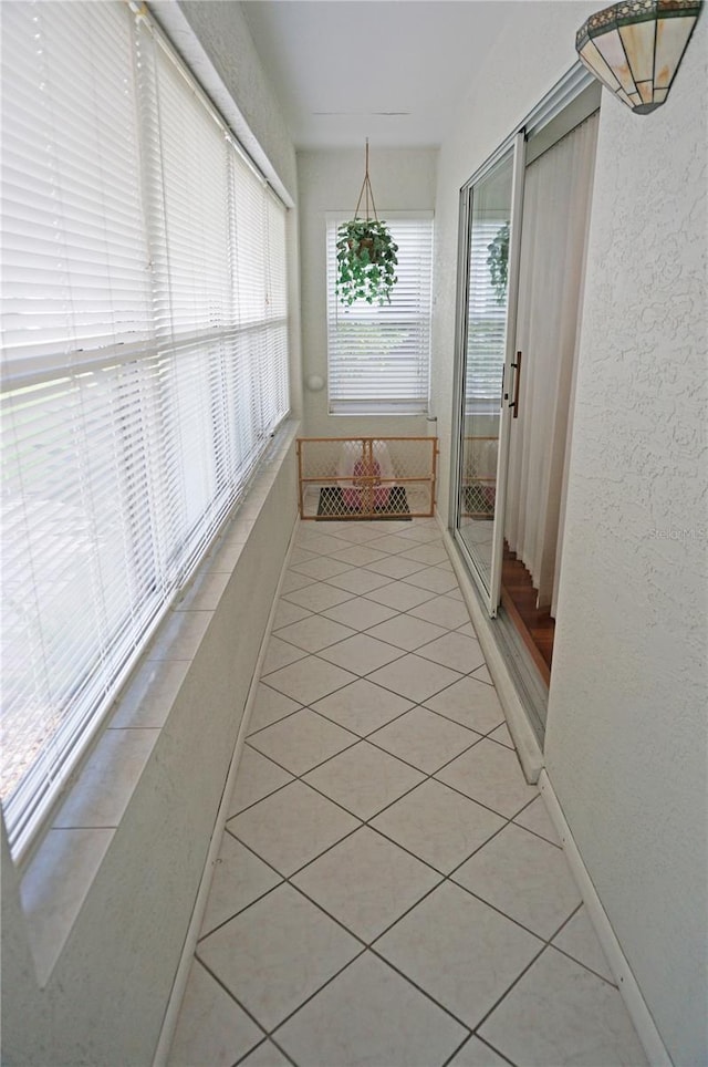 hall with light tile patterned flooring