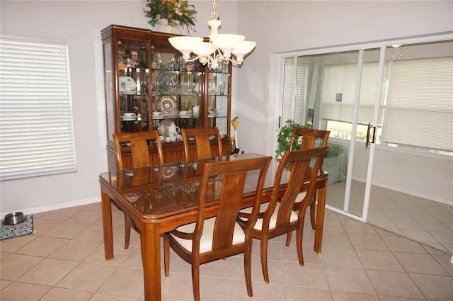 tiled dining space with a notable chandelier