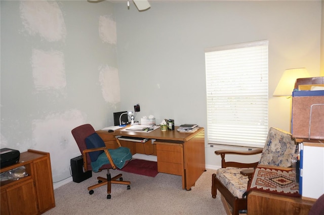 carpeted office space featuring ceiling fan