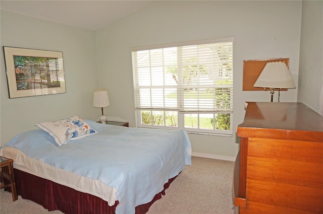 carpeted bedroom with vaulted ceiling