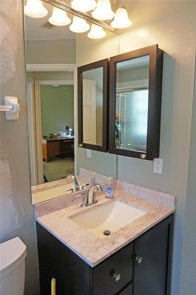 bathroom featuring vanity and toilet