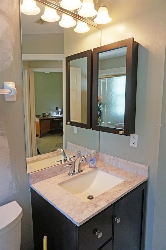 bathroom featuring toilet and vanity