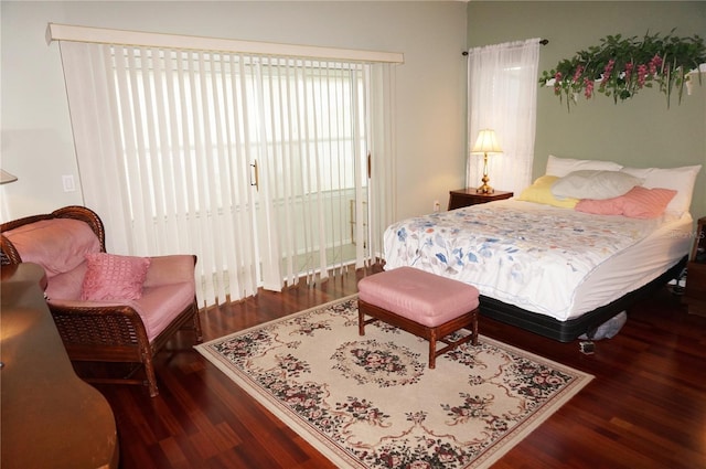 bedroom with dark wood-type flooring