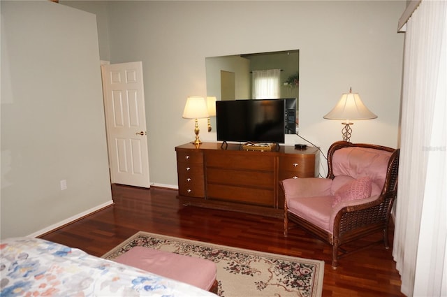 bedroom with dark wood-type flooring