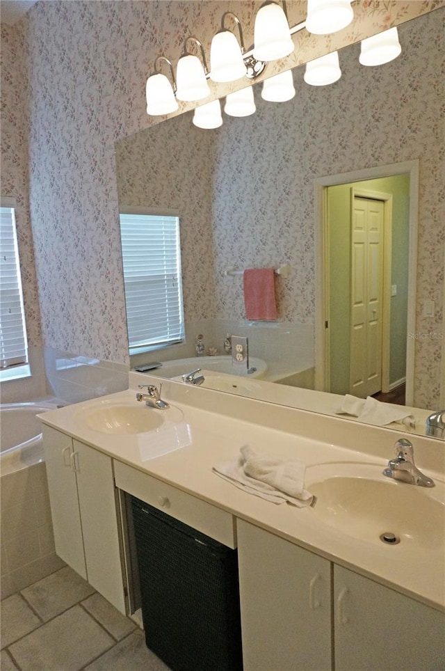 bathroom with double sink vanity, a tub to relax in, and tile patterned flooring