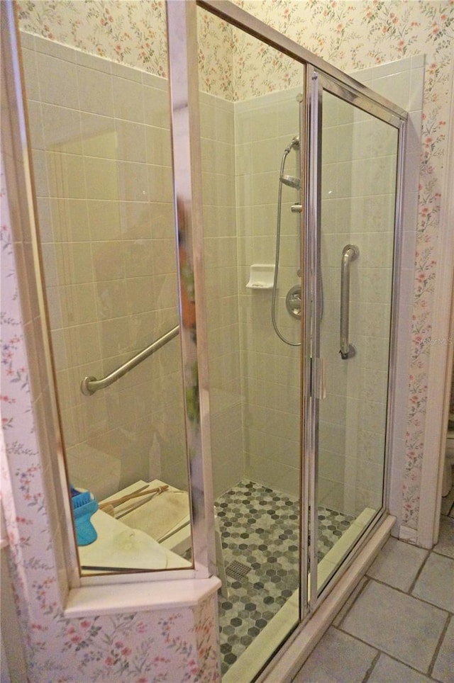 bathroom featuring an enclosed shower and tile patterned floors