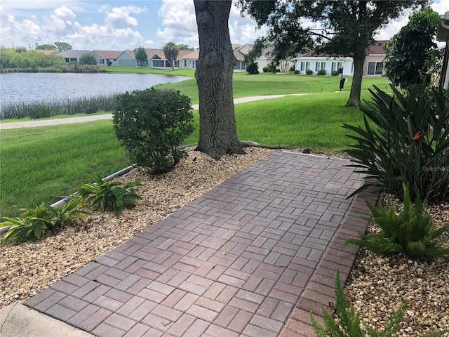 exterior space featuring a water view and a yard