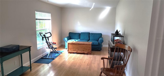 sitting room with light wood-type flooring and baseboards