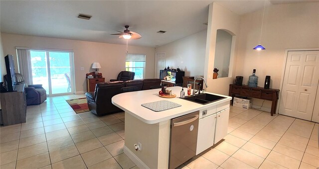 kitchen with light tile patterned floors, plenty of natural light, dishwasher, open floor plan, and a sink