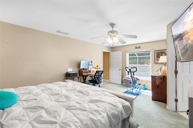 bedroom featuring baseboards, ceiling fan, visible vents, and light colored carpet