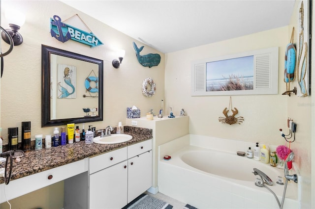 bathroom with a garden tub and vanity