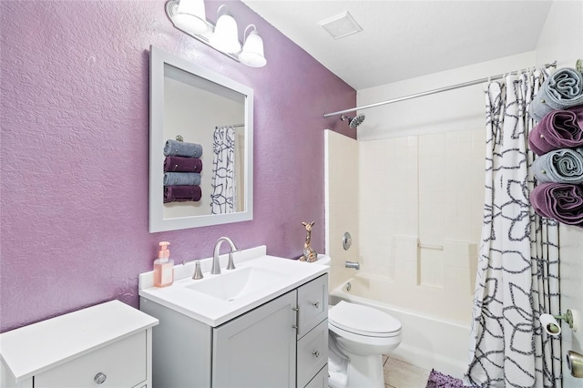 bathroom featuring a textured wall, toilet, visible vents, vanity, and shower / tub combo with curtain