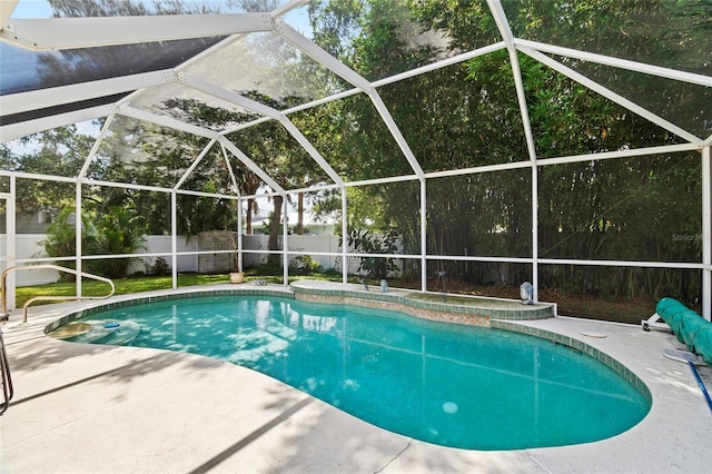 view of pool featuring a patio, glass enclosure, a fenced backyard, and a fenced in pool