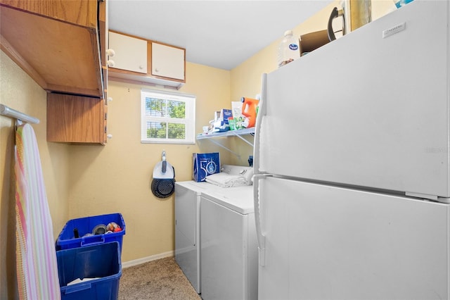 laundry room featuring cabinet space, baseboards, carpet flooring, and washing machine and clothes dryer