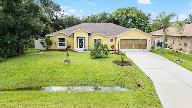 ranch-style home with a garage, a front yard, driveway, and stucco siding