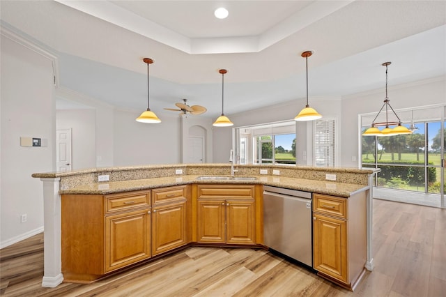 kitchen with light hardwood / wood-style flooring, sink, light stone counters, hanging light fixtures, and dishwasher