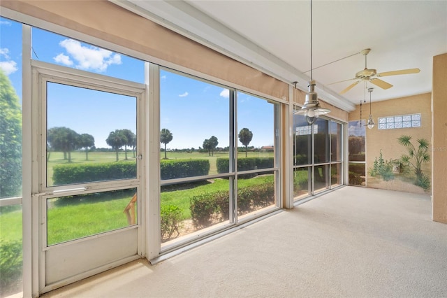 unfurnished sunroom featuring ceiling fan