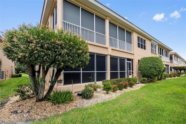 rear view of property featuring a yard