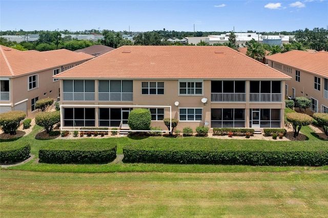 rear view of property featuring a lawn